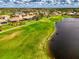 Overhead view of community featuring golf course, lake, and well-maintained landscaping at 5371 White Ibis Dr, North Port, FL 34287