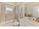 Well lit bathroom featuring a glass enclosed shower and tile surround at 5371 White Ibis Dr, North Port, FL 34287