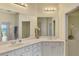 Bright bathroom with white cabinets, double sinks and plenty of counter space at 5371 White Ibis Dr, North Port, FL 34287