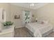 Bright bedroom with light-colored walls, wood floors, and a window view at 5371 White Ibis Dr, North Port, FL 34287