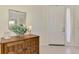 Inviting entryway featuring neutral tile, decorative wooden cabinet, and a mirror at 5371 White Ibis Dr, North Port, FL 34287