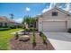 Attractive front exterior with a two-car garage and manicured landscaping in a neighborhood at 5371 White Ibis Dr, North Port, FL 34287