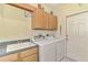 Laundry room featuring a sink, cabinetry, washer, and dryer at 5371 White Ibis Dr, North Port, FL 34287