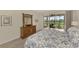 Relaxing main bedroom with wood floors, dresser and private access to the lanai at 5371 White Ibis Dr, North Port, FL 34287