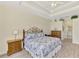 Well-lit main bedroom with wood floors and decorative tray ceiling at 5371 White Ibis Dr, North Port, FL 34287