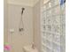 Bathroom shower with glass block privacy wall at 5371 White Ibis Dr, North Port, FL 34287