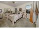 Cozy bedroom featuring neutral carpet, a ceiling fan, and stylish decor with natural lighting from two windows at 564 Meadow Sweet Cir, Osprey, FL 34229