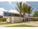 Modern beachfront building with palm trees and 'Siesta Beach' inscribed on the facade at 564 Meadow Sweet Cir, Osprey, FL 34229