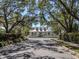 Charming two-story home with a welcoming front porch and mature trees at 564 Meadow Sweet Cir, Osprey, FL 34229