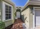 Inviting front entrance featuring a brick walkway, charming bench, and views of the home's facade at 564 Meadow Sweet Cir, Osprey, FL 34229