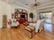 Bright living room showcasing hardwood floors and an entertainment center, complemented by comfortable seating at 564 Meadow Sweet Cir, Osprey, FL 34229