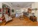 Expansive living room that includes a ceiling fan, wood flooring, a view of the patio, and kitchen bar seating at 564 Meadow Sweet Cir, Osprey, FL 34229