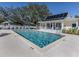 Large in-ground pool with clear water, surrounded by a spacious concrete deck at 564 Meadow Sweet Cir, Osprey, FL 34229