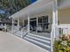 Inviting pool deck featuring a covered area with chairs and well-maintained landscaping at 564 Meadow Sweet Cir, Osprey, FL 34229