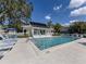 Community pool featuring clear blue water, lounge chairs, and a poolside clubhouse at 564 Meadow Sweet Cir, Osprey, FL 34229