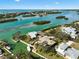 Stunning aerial view showcasing waterfront homes with boat docks and access to the beautiful turquoise water of the bay at 641 Bayshore Rd, Nokomis, FL 34275