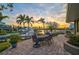 Inviting outdoor patio area with a dining set, lush greenery, and beautiful water views at 641 Bayshore Rd, Nokomis, FL 34275