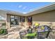 Relaxing patio featuring wicker furniture, brick flooring, and sliding glass doors into the house at 641 Bayshore Rd, Nokomis, FL 34275