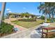 The backyard leads to the waterfront featuring a brick patio, landscaping, and an ADT security system at 641 Bayshore Rd, Nokomis, FL 34275