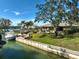 Beautiful backyard featuring mature landscaping, an outdoor seating area, private dock, and waterfront access at 641 Bayshore Rd, Nokomis, FL 34275