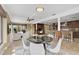 Dining area with modern table set, tile flooring, and views of the living room and kitchen at 641 Bayshore Rd, Nokomis, FL 34275