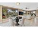 Dining area with water view, modern table set, neutral paint and light, tile flooring at 641 Bayshore Rd, Nokomis, FL 34275