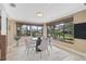 Dining area with water view, modern table set, neutral paint and light, tile flooring at 641 Bayshore Rd, Nokomis, FL 34275