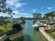 A private dock offering waterfront access and boat lifts, surrounded by lush landscaping and calm waters at 641 Bayshore Rd, Nokomis, FL 34275