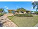 The exterior of the home features steps up to outdoor seating and lush landscaping at 641 Bayshore Rd, Nokomis, FL 34275