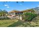 Lush landscaped yard with a brick patio surrounds the exterior of this single-story home at 641 Bayshore Rd, Nokomis, FL 34275