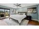 Stylish main bedroom with hard wood floors, ceiling fan, a large bed and great natural light at 641 Bayshore Rd, Nokomis, FL 34275