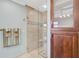 Luxurious shower with glass enclosure, bench, and decorative tile accents in neutral color palette at 641 Bayshore Rd, Nokomis, FL 34275