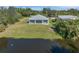 Aerial view of house backing up to a pond at 7057 Regina Dr, Englewood, FL 34224