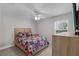 Guest bedroom with a patriotic quilt and ceiling fan at 7057 Regina Dr, Englewood, FL 34224