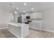 Modern kitchen with gray cabinets, marble island, and stainless steel appliances at 7057 Regina Dr, Englewood, FL 34224