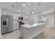 Modern kitchen with gray cabinets, white countertops, and an island at 7057 Regina Dr, Englewood, FL 34224