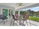 Relaxing screened porch with patio furniture overlooking a pond at 7057 Regina Dr, Englewood, FL 34224