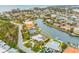 Aerial view of waterfront home with pool and lush landscaping at 721 Binnacle Point Dr, Longboat Key, FL 34228