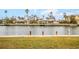 View of a canal with houses and boats in a waterfront community at 721 Binnacle Point Dr, Longboat Key, FL 34228