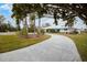 Curved driveway leading to a white house with palm trees at 721 Binnacle Point Dr, Longboat Key, FL 34228