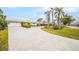 Landscaped front yard with circular driveway and palm trees at 721 Binnacle Point Dr, Longboat Key, FL 34228