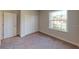 Bright bedroom with carpet flooring and a window at 5113 Hablow Ln, North Port, FL 34286
