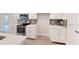 Modern kitchen features white cabinets, quartz countertops, and stainless steel appliances at 5113 Hablow Ln, North Port, FL 34286