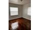 A bright bedroom with hardwood floors and two windows at 510 26Th St S, St Petersburg, FL 33712