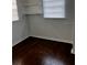 A bedroom with hardwood floors, window, and closet shelves at 510 26Th St S, St Petersburg, FL 33712