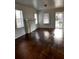 A bright living room boasts hardwood floors, a fireplace, and natural light through several windows at 510 26Th St S, St Petersburg, FL 33712