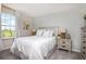 Well-lit bedroom featuring a light color scheme, plush bedding and an abundance of natural light at 10719 Ironwood Tree Way, San Antonio, FL 33576