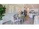 Dining room with neutral decor, tiled floors and natural light with open view to the kitchen at 10719 Ironwood Tree Way, San Antonio, FL 33576