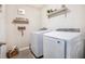 The laundry room has a modern washer and dryer, shelving and decor at 10719 Ironwood Tree Way, San Antonio, FL 33576