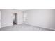 Bright bedroom with grey carpet and en-suite bathroom at 25503 Calusa Dr, Punta Gorda, FL 33955